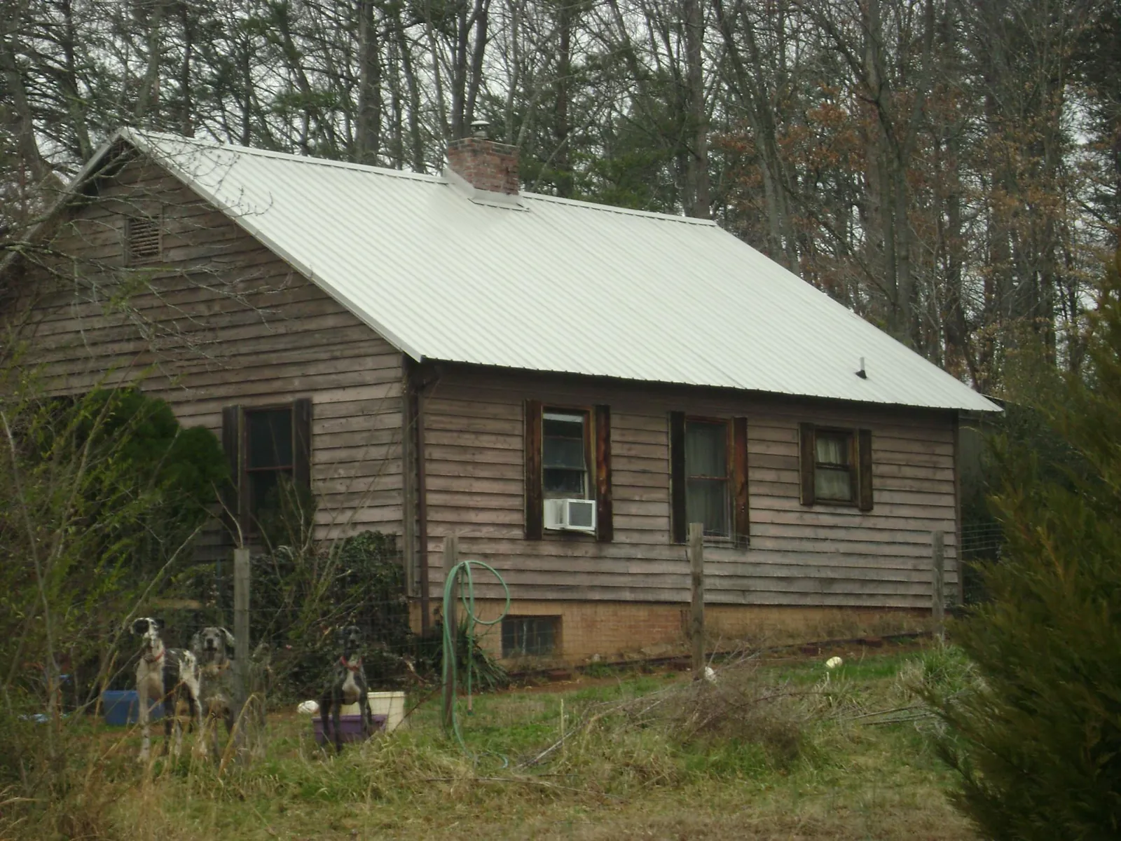 White metal roof on an old wood sided farmhouse, from a Metal Roof Installation job in Latonia